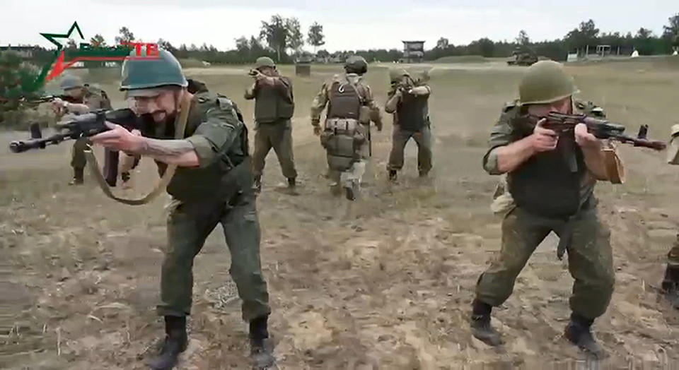 In this photo taken from video released by Belarusian Defense Ministry via VoenTV on Friday, July 14, 2023, Belarusian soldiers attend a training by mercenary fighters from Wagner private military company near Tsel village, about 90 kilometers (about 55 miles) southeast of Minsk, Belarus. Mercenary fighters from the Wagner private military company are training Belarusian soldiers in Belarus, the country's Defense Ministry said Friday. Russian President Vladimir Putin said he offered the Wagner private military company the option of continuing to serve as a single unit under their same commander. (Belarusian Defense Ministry via VoenTV via AP)