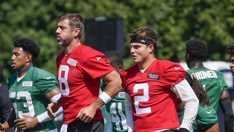 New York Jets quarterbacks Aaron Rodgers (8) and Zach Wilson (2) warm up during practice at the team’s training facility on Friday, July 21, 2023, in Florham Park, N.J.