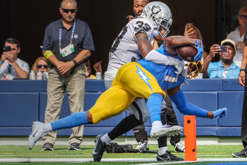 Inglewood, CA, Sunday, September 11, 2022 - Los Angeles Chargers tight end Gerald Everett (7) pushes into the end zone despite the efforts of Las Vegas Raiders safety Roderic Teamer (33) for a third quarter touchdown at SoFi Stadium. (Robert Gauthier/Los Angeles Times)