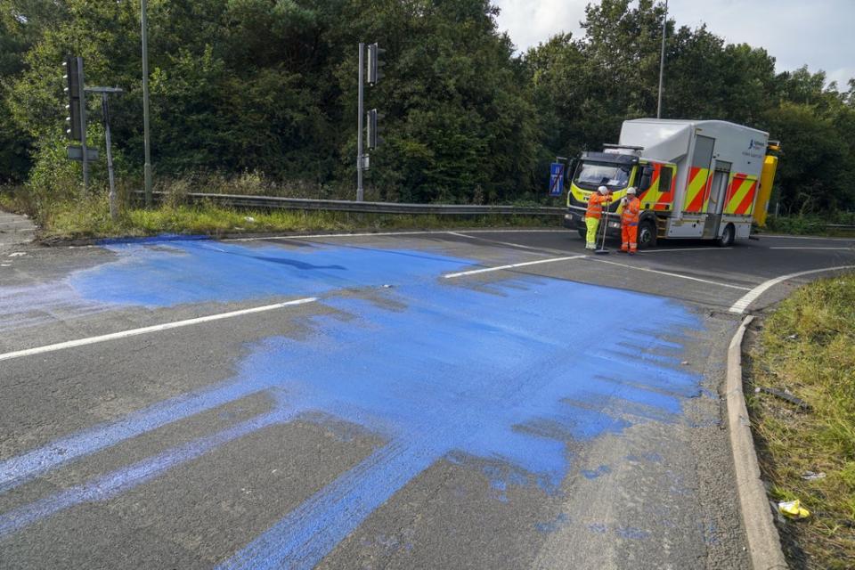 Highways England workers on the exit slip road of the M25 motorway near Leatherhead (Steve Parsons/PA) (PA Wire)