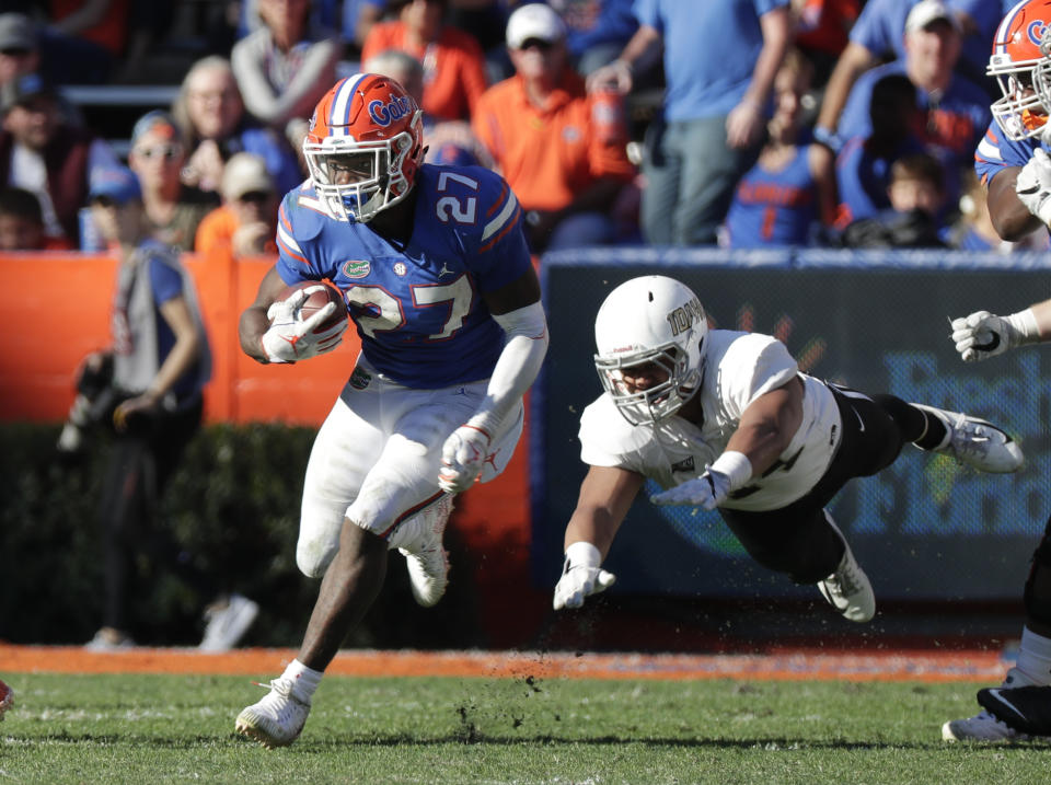 Florida running back Dameon Pierce (27) runs past Idaho defensive lineman Ben Taliulu for yardage during the second half of an NCAA college football game, Saturday, Nov. 17, 2018, in Gainesville, Fla. (AP Photo/John Raoux)