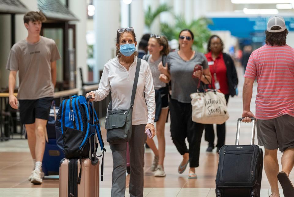 Passengers crowd Palm Beach International Airport Friday during the busy Fourth of July weekend.