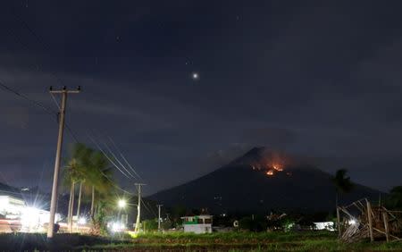 Fire is seen on the slopes of Mount Agung volcano following an eruption as seen from Amed in Karangasem Regency, Bali, Indonesia July 3, 2018. REUTERS/Johannes P. Christo