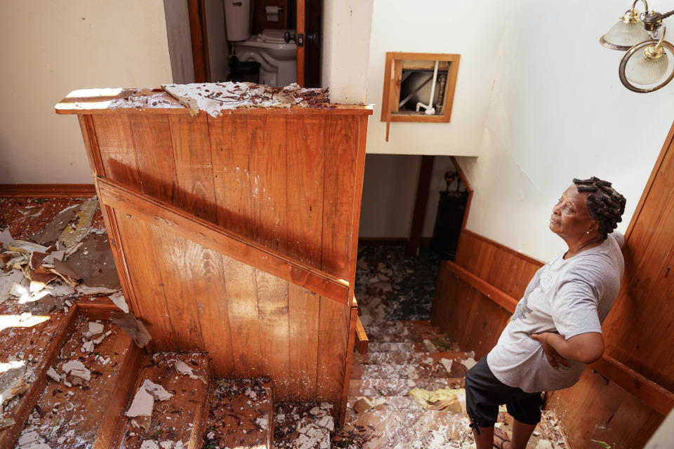 Patricia Henderson stands in the stairway at her home, which lost its roof during Hurricane Ida, on Tuesday in Ponchatoula, La.