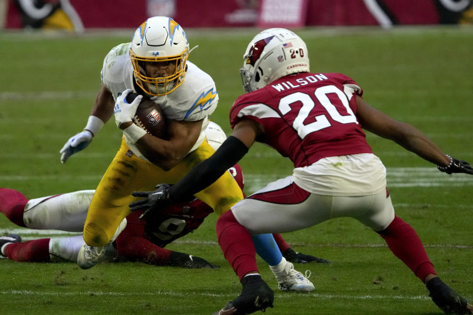 Los Angeles Chargers running back Austin Ekeler runs as Arizona Cardinals cornerback Marco Wilson (20) defends during the second half of an NFL football game, Sunday, Nov. 27, 2022, in Glendale, Ariz. The Chargers defeated the Cardinals 25-24. (AP Photo/Rick Scuteri)
