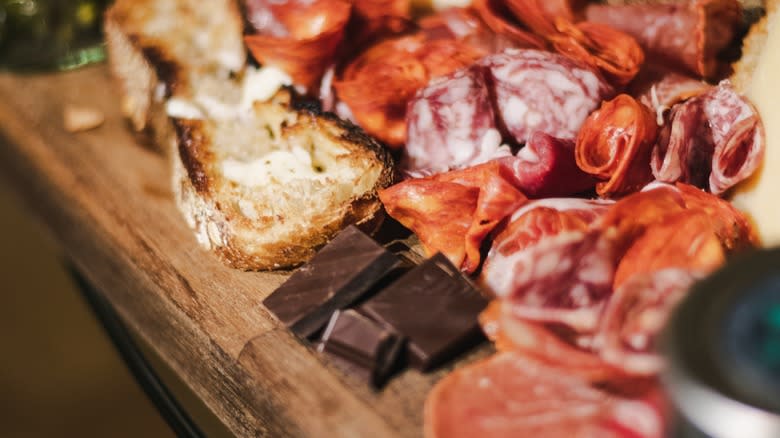 chocolate and cured meats on charcuterie board, bread