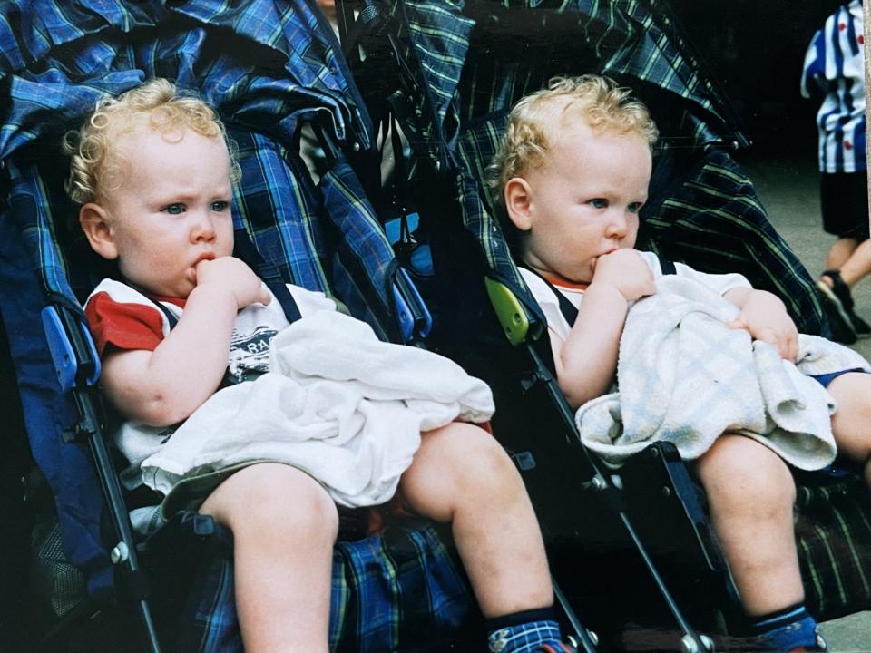Luke and Owen Buckmaster sitting in prams as toddlers.
