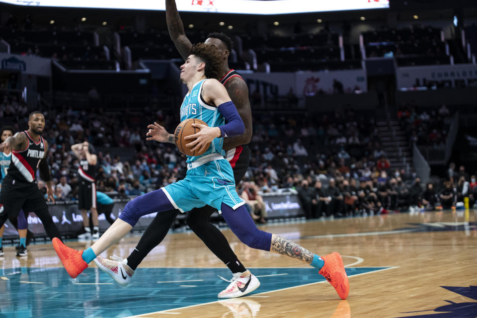 Charlotte Hornets guard LaMelo Ball (2) drives past Portland Trail Blazers forward Nassir Little (9) during the first half of an NBA basketball game, Sunday, Oct. 31, 2021, in Charlotte, N.C. (AP Photo/Matt Kelley)