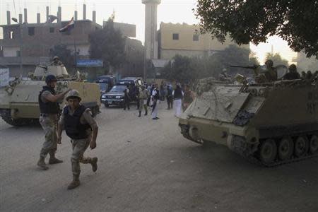 Security forces take their positions during clashes with gunmen in Kerdasa, a town 14 km (9 miles) from Cairo, September 19, 2013. REUTERS/Stringer