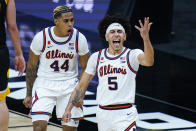 Illinois guard Andre Curbelo (5) celebrates with Adam Miller (44) after scoring following a steal against Iowa in the first half of an NCAA college basketball game at the Big Ten Conference tournament in Indianapolis, Saturday, March 13, 2021. (AP Photo/Michael Conroy)