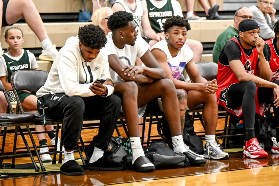 From left, Michigan State basketball players Jase Richardson, Xavier Booker and Jeremy Fears take in the action in the first game on Tuesday, June 25, 2024, during the Moneyball Pro-Am at Holt High School.