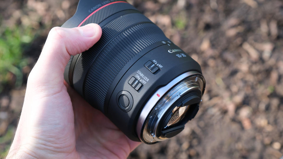 Canon RF 10-20mm F4L IS STM lens held in a hand