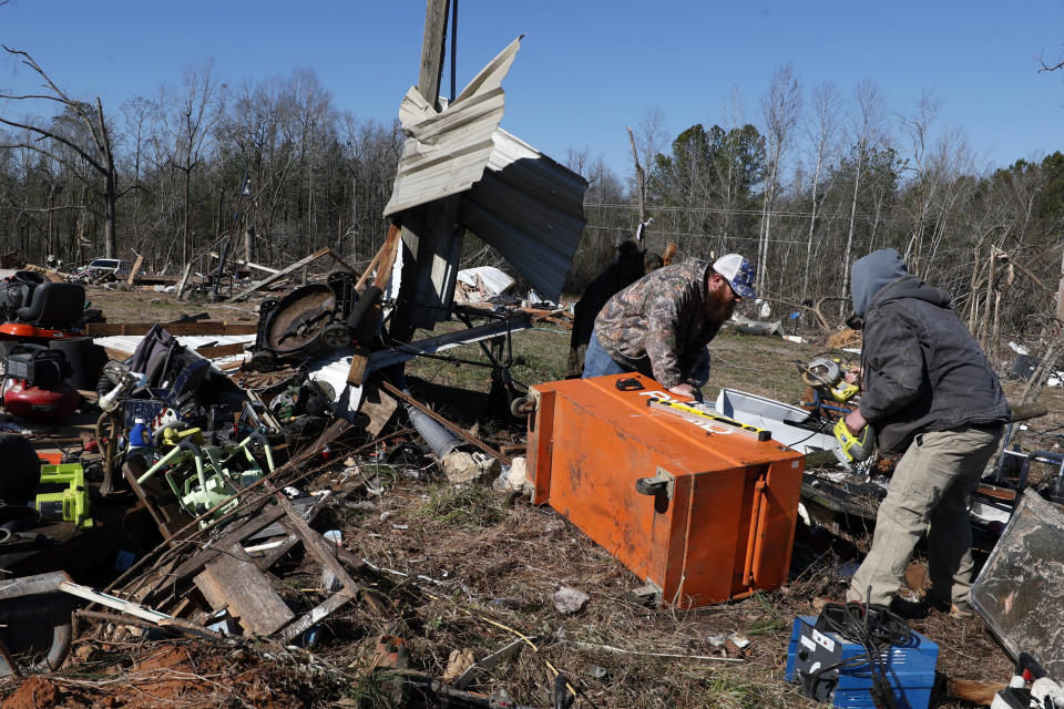 Friends and family help sift through debris looking for personal items as they recover from a tornado that ripped through Central Alabama earlier this week Saturday, Jan. 14, 2023, in Marbury, Ala. (AP Photo/Butch Dill)