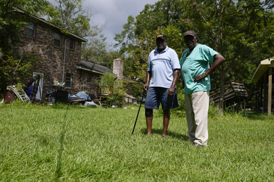 Fred Smalls, 67, left, and his brother Elijah Smalls Jr., 80, pose for a portrait on their family's property, Thursday, July 27, 2023, in Phillips Community, an unincorporated area near Mount Pleasant, S.C. (AP Photo/Erik Verduzco)