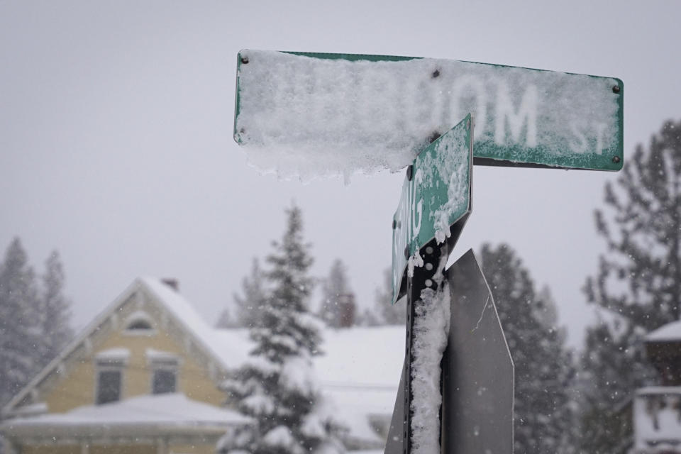 Snow covers street signs at an intersection during a storm, Sunday, March 3, 2024, in Truckee, Calif. (AP Photo/Brooke Hess-Homeier)