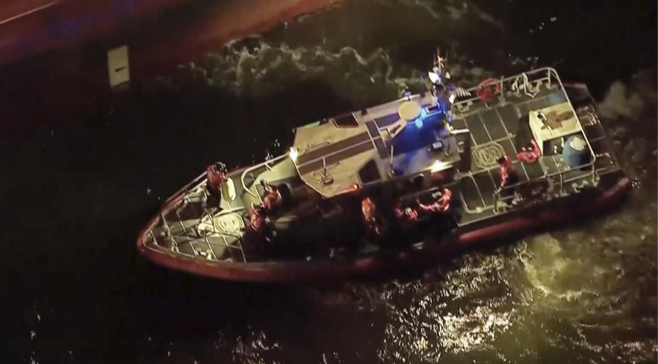 Rescued sailors are seen on board a smaller boat after leaving the Silver Muna tanker ship on Wednesday, Dec. 14, 2022 in New York. Two men who went missing in the Atlantic Ocean for 10 days after a storm hit their sailboat off North Carolina thanked the crew of the tanker that rescued them and said they were lucky to have survived. (WABC via AP)