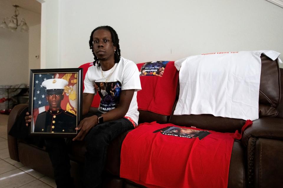 Jalen Richardson holds a photo on Tuesday, July 12, 2022 of his cousin Malique Richardson, a 24-year-old former Marine who was killed last week in Tallahassee, Fla. 