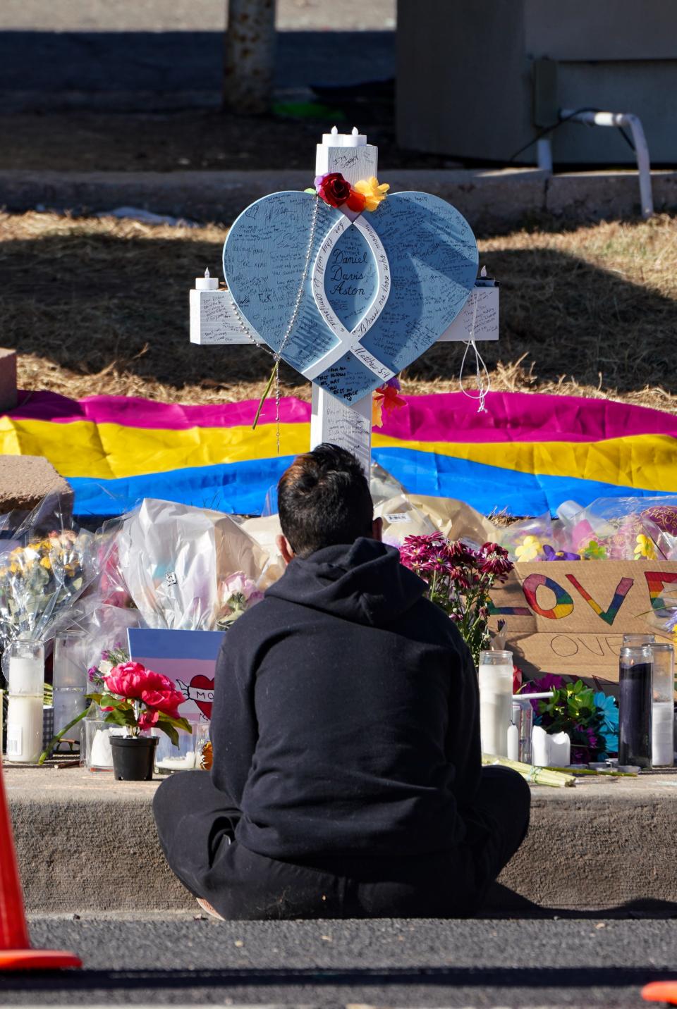 People pay their respects at a memorial display set up to remember the five victims of the Club Q shooting in Colorado Springs, Colorado, on Tuesday, Nov. 22, 2022.