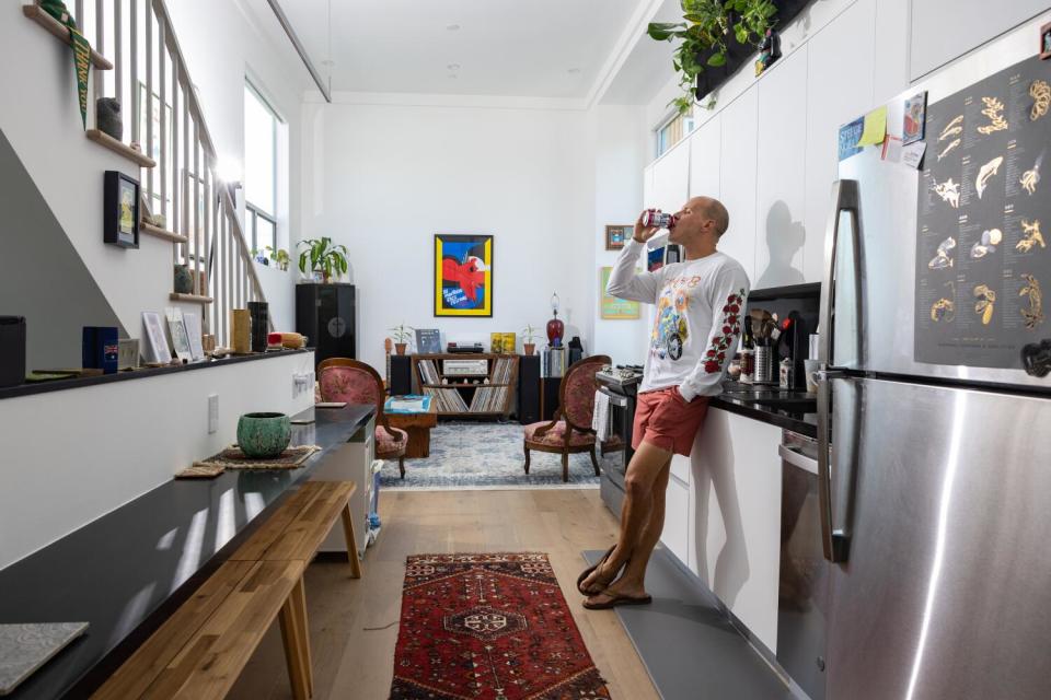 Attorney Henry Schober III drinks a can of seltzer in the kitchen.