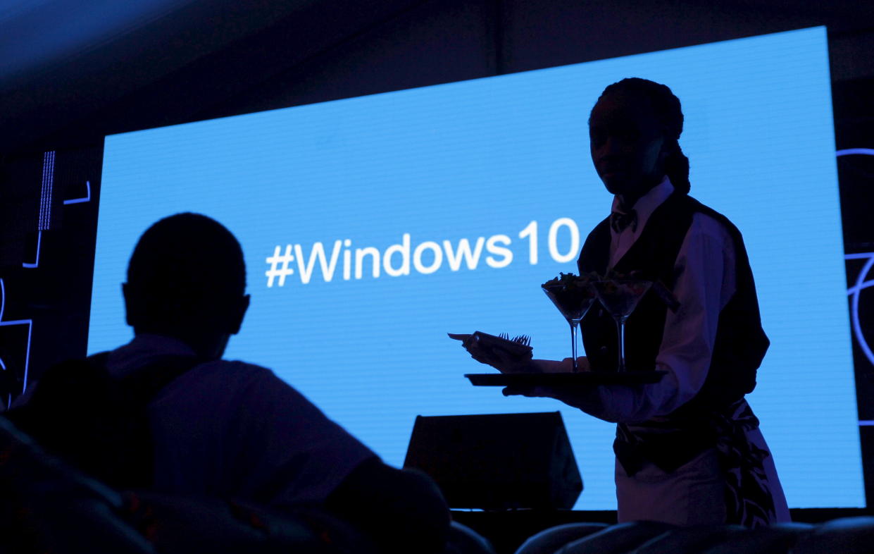 A waitress serves a Microsoft delegate during the launch of the Windows 10 operating system in Kenya's capital Nairobi, July 29, 2015. Microsoft Corp's launch of its first new operating system in almost three years, designed to work across laptops, desktop and smartphones, won mostly positive reviews for its user-friendly and feature-packed interface. REUTERS/Thomas Mukoya