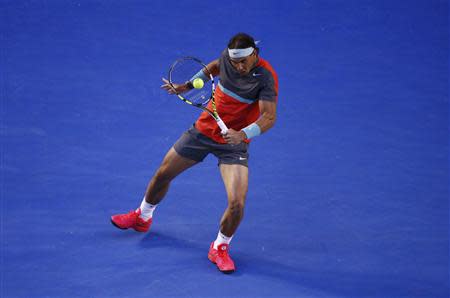 Rafael Nadal of Spain hits a return to Roger Federer of Switzerland during their men's singles semi-final match at the Australian Open 2014 tennis tournament in Melbourne January 24, 2014. REUTERS/David Gray