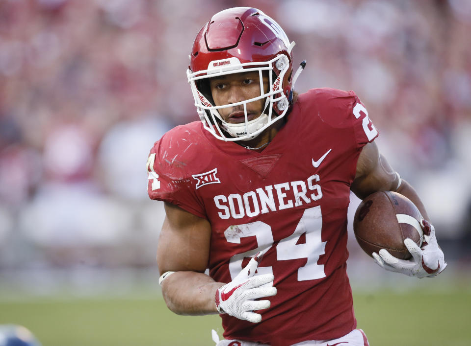 FILE – In this , Saturday, Nov. 25, 2017 file photo, Oklahoma running back Rodney Anderson (24) carries in the second quarter of an NCAA college football game against West Virginia in Norman, Okla. Anderson, one of Oklahoma’s breakout stars this year, is accused of sexual assault. (AP Photo/Sue Ogrocki, File)