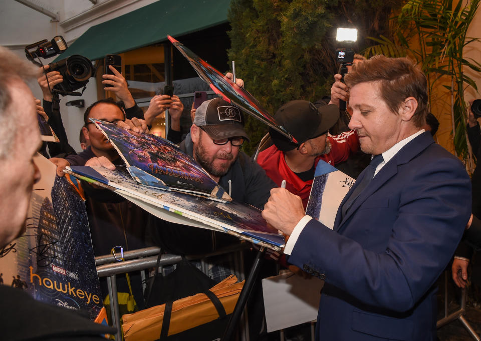 Jeremy Renner signs autographs at the premiere of Disney+'s Rennervations. (Photo: Frank Micelotta/PictureGroup for Disney Television Studios)