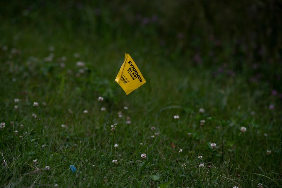 A flag declaring evidence is placed off Natchez Trace following a plane crash where three people were killed in Williamson County, Tenn., Wednesday, May 15, 2024. The plane departed from Baton Rouge, Louisiana and was headed to Louisville, Kentucky when it crashed.