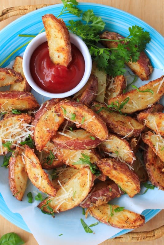 <p>The Two Bite Club</p><p>Parmesan red potato wedges are coated with shredded parmesan cheese, herbs, and spices before baking in the oven until they are golden and crispy.</p><p><strong>Get the recipe: <a href="https://www.thetwobiteclub.com/2017/08/parmesan-red-potato-wedges.html" rel="nofollow noopener" target="_blank" data-ylk="slk:Parmesan Red Potato Wedges;elm:context_link;itc:0;sec:content-canvas" class="link rapid-noclick-resp">Parmesan Red Potato Wedges</a></strong></p>