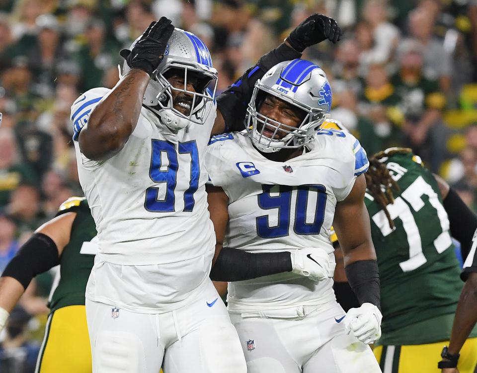 Lions defensive linemen Nick Williams, left, and Trey Flowers reacts to a sack against the Packers during the first half on Monday, Sept. 20, 2021, in Green Bay, Wisconsin.