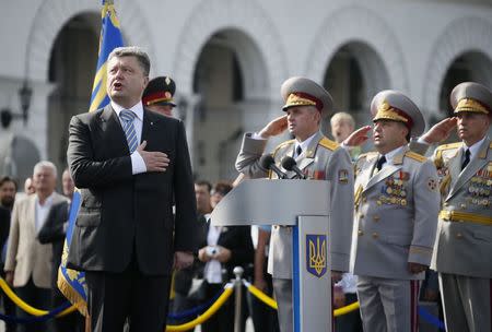 Ukraine's President Petro Poroshenko (L, front) sings a national anthem during the Independence Day military parade, in the center of Kiev August 24, 2014. REUTERS/Gleb Garanich