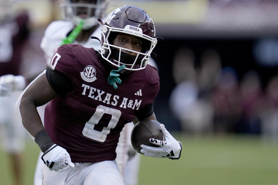 Texas A&M wide receiver Ainias Smith (0) breaks free from an Alabama defender during a catch and run for a first down in the second half of an NCAA college football game Saturday, Oct. 7, 2023, in College Station, Texas. (AP Photo/Sam Craft)