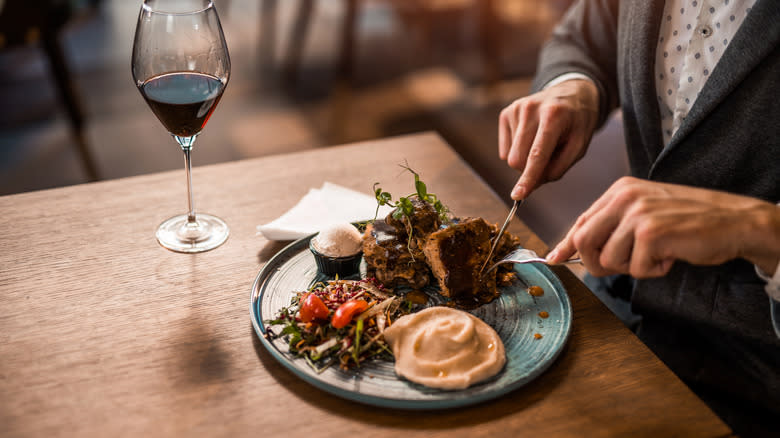 Person enjoying a meal in a restaurant