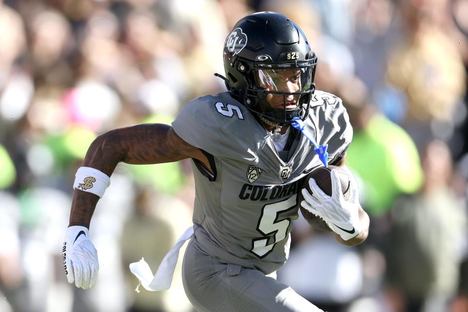 BOULDER, COLORADO - NOVEMBER 11: Jmmy Horn Jr. #5 of the Colorado Buffaloes carries the ball against the Arizona Wildcats in the fourth quarter at Folsom Field on November 11, 2023 in Boulder, Colorado. (Photo by Matthew Stockman/Getty Images)