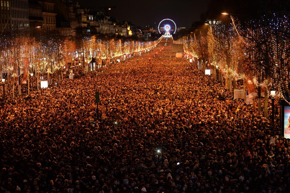 New Year revelers gather on the Champs-Elysees avenue in Paris on December 31, 2017. (Photo: GUILLAUME SOUVANT via Getty Images)