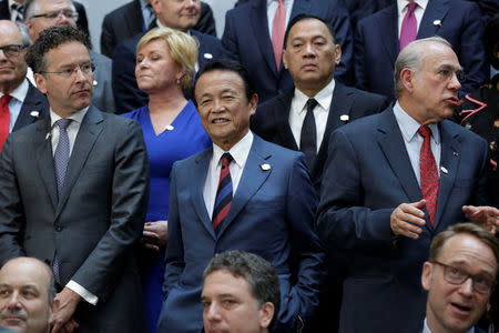Japanese Finance Minister Taro Aso (C) poses for G-20 family photo during the IMF/World Bank spring meetings in Washington, U.S., April 21, 2017. REUTERS/Yuri Gripas