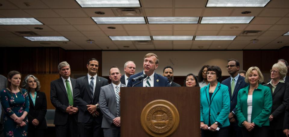 Flanked by the Board of Trustees and members of the presidential search committee, newly announced Michigan State University President Samuel Stanley Jr. addresses the press Tuesday, May 28, 2019.