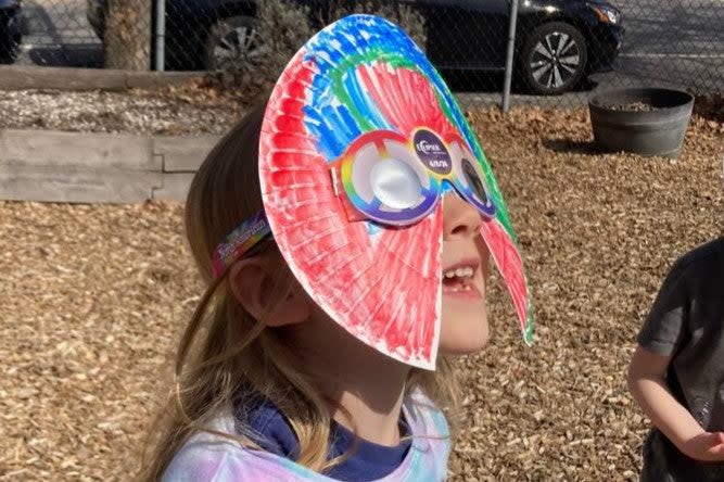 Céleste Early-Mahiet watches the partial solar eclipse from Providence, Rhode Island, on 8 April, 2024 (Angela Early)