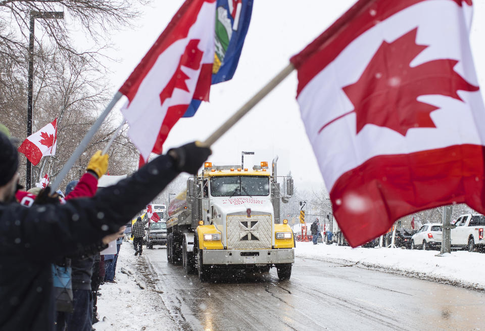 People gather in protest against COVID-19 mandates and in support of a protest against COVID-19 restrictions taking place in Ottawa, in Edmonton, Alberta, Saturday, Feb. 5, 2022. (Jason Franson/The Canadian Press via AP)