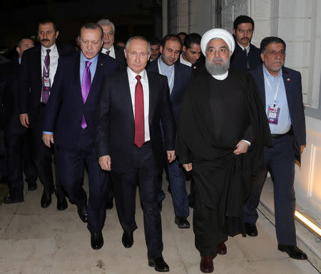 Russia's President Vladimir Putin walks with his counterparts Tayyip Erdogan of Turkey, and Hassan Rouhani of Iran after a joint news conference in Sochi, Russia, November 22, 2017. Sputnik/Mikhail Klimentyev/Kremlin via REUTERS ATTENTION EDITORS - THIS IMAGE WAS PROVIDED BY A THIRD PARTY.