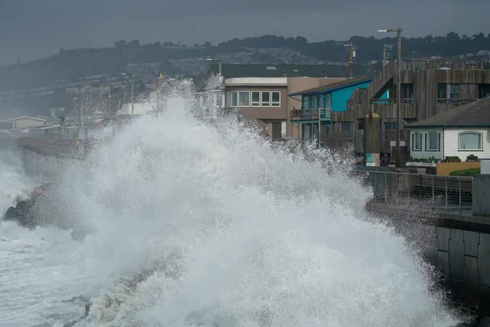 Large waves crash into a seawall in Pacifica, Calif., on Jan. 6, 2023. Giant waves, measuring as high as 13 feet, are becoming more common off California's Pacific coast as the planet warms, according to new research that used a unique approach to gather historical data over the past 90 years to track the increasing height of the surf.