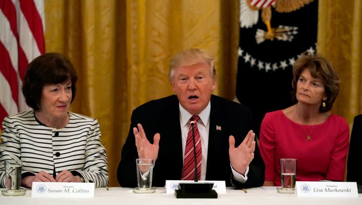 Sen. Susan Collins, left, and Sen. Lisa Murkowski sitting next to President Trump at a health care roundtable Tuesday. (Photo: Kevin Lamarque/Reuters)