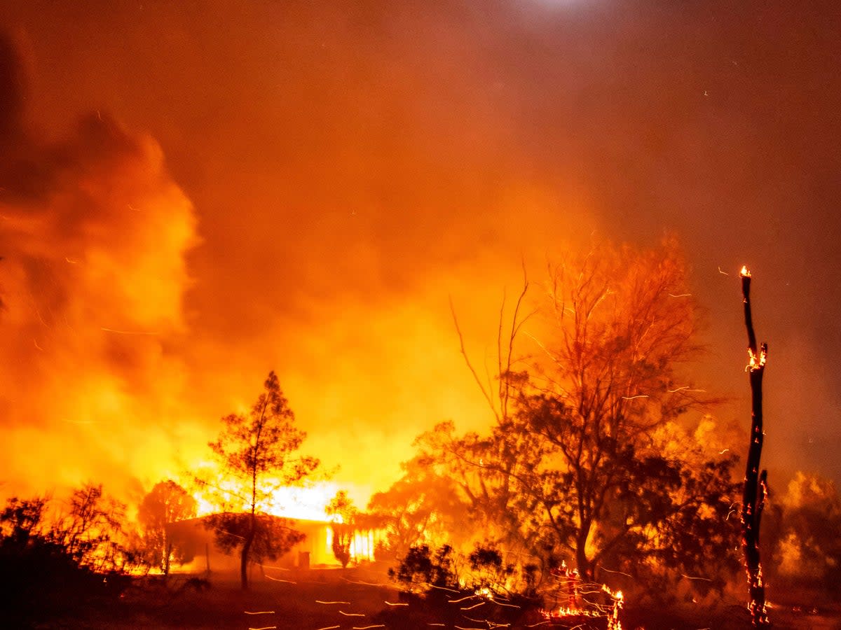 A structure is engulfed in flames as the Highland Fire burns in Aguanga, California on Monday, October 30, 2023 (AP)