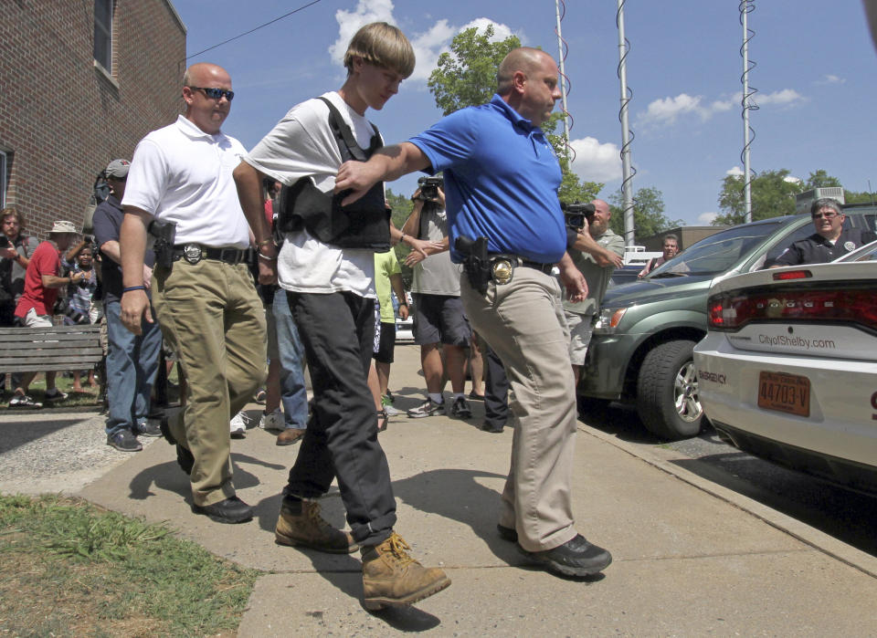 Charleston, S.C., shooting suspect Dylann Storm Roof is escorted from the Sheby Police Department  in Shelby, N.C., Thursday, June 18, 2015. 