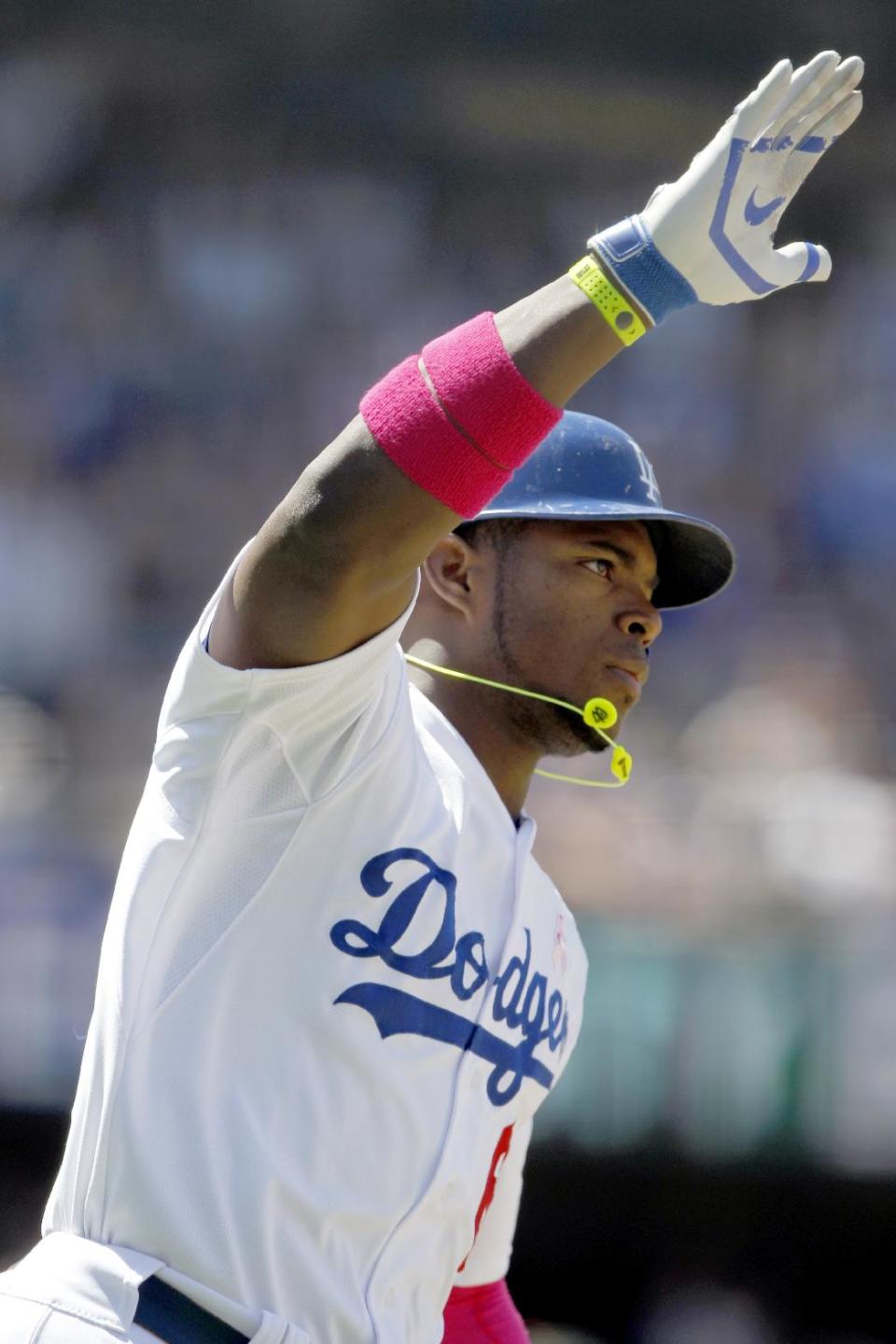 Los Angeles Dodgers’ Yasiel Puig rounds first as he raises his arm after hitting a solo home run against the San Francisco Giants in the sixth inning of a baseball game on Sunday, May 11, 2014, in Los Angeles. (AP Photo/Alex Gallardo)