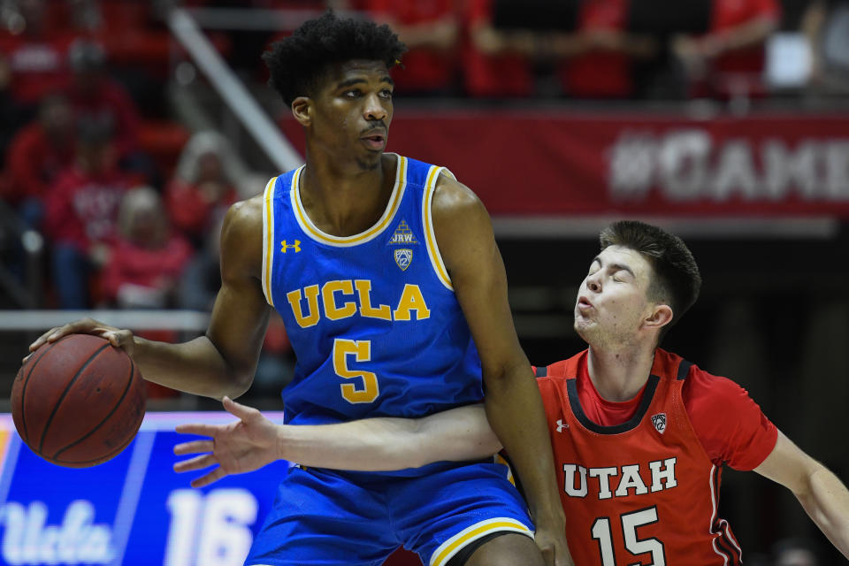 UCLA guard Chris Smith (5) attempts to dribble around Utah guard Rylan Jones (15) during the first half of an NCAA college basketball game Thursday, Feb. 20, 2020, in Salt Lake City. (AP Photo/Alex Goodlett)