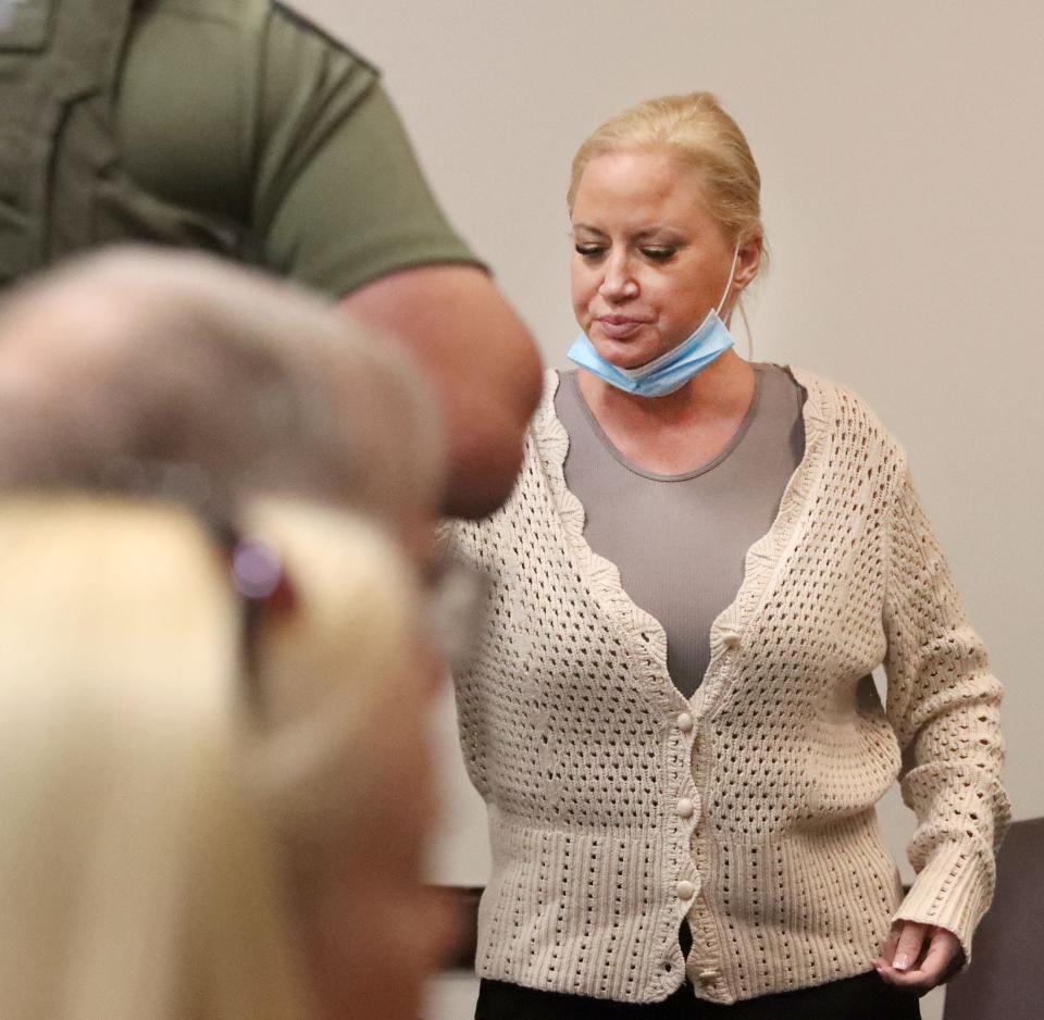 Tammy Sytch hands her jewelry to her fiancé, James Pente, as she is taken into custody, Friday, May 13, 2022, after her bond for a drunk driving causing death charge was revoked.