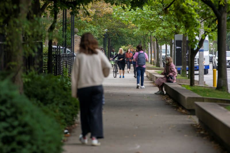 Students walk on the grounds of the University of Toronto in Toronto