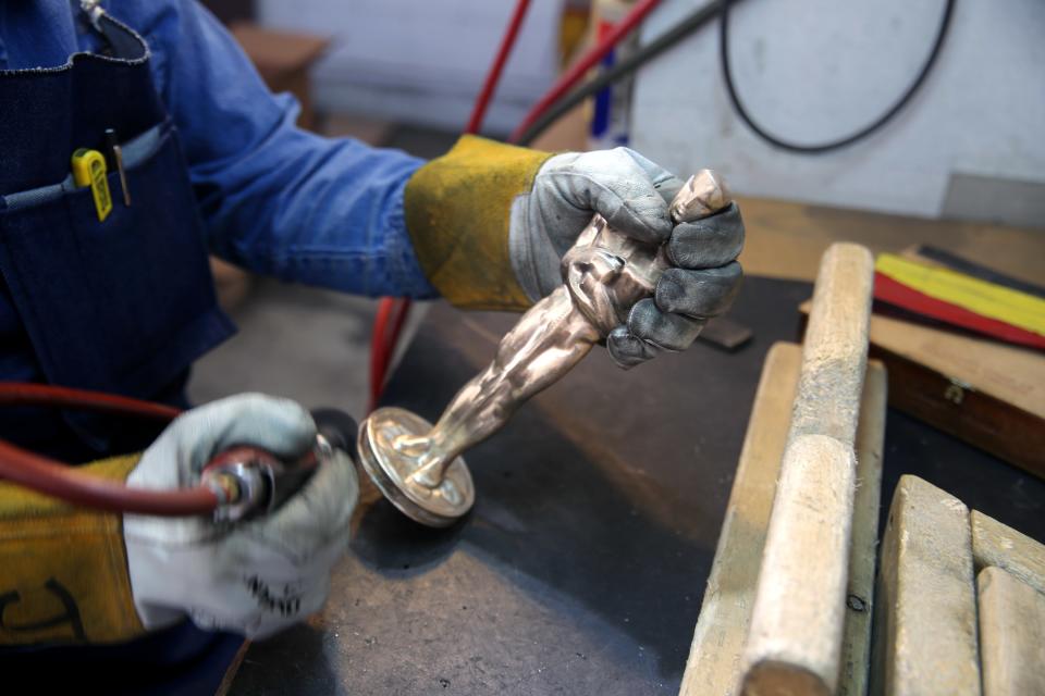 The bronze mold of an Oscar is hand polished before being plated in gold.