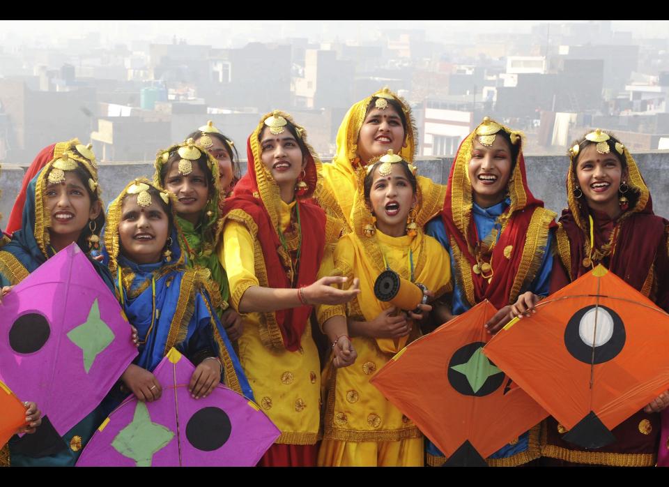 Indian girls dressed as Punjabi folk dancers smile as they fly kites, at the Jagat Jyoti High School in Amritsar prior to the Lohri festival. The Lohri festival is an annual thanks giving day and an extremely popular harvest festival in India, especially Northern India.